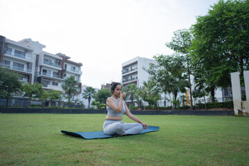 Indian woman practicing yoga in park