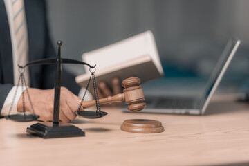 legal concept Legal Advice Lawyer Online Consultation Gavel in focus Laptop. Scales of Justice...