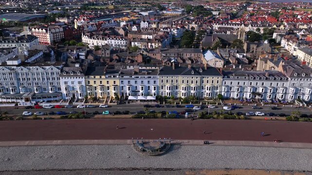 Aerial view of Llandudno, Wales, showcasing the sweeping promenade lined with Victorian seafront buildings.