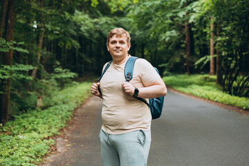 Young 30s man hiking in nature. Travel, adventure. Concept of an active lifestyle. High quality...