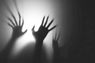 Shadow overlay effect for halloween background with Terrifying scary hands with long nails,Creepy monster claw,silhouette of hands,zombie hand rising out of a graveyard