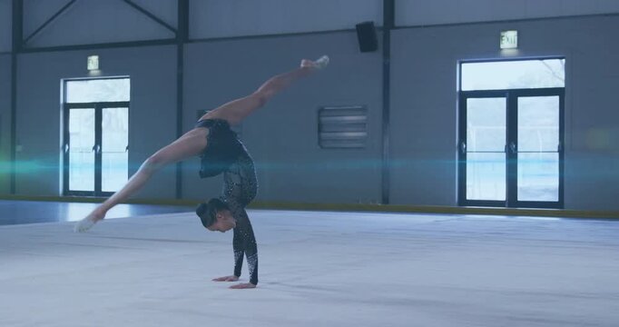Female gymnast arching torso on floor, executing rotating split handstand for sports training