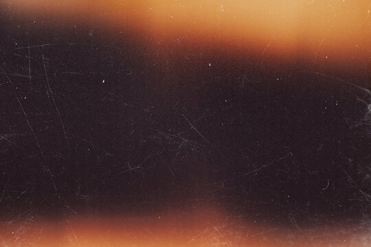 retro film burn overlay effect with scratch dust and moion blur orange light leaks,retro grain noisy film distressed texture light leak flare on black background,old film texture