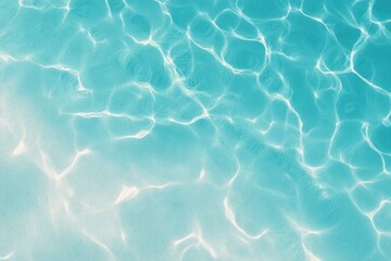 Sun-dappled light refracts through clear turquoise water, creating mesmerizing patterns on a bright sandy bottom