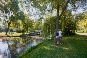 Fototapeta premium Father and daughter in the park on a summer morning spending time together enjoying nature.