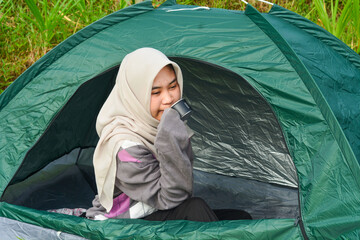 Asian Muslim woman and young Asian Muslim girl wake up in camp