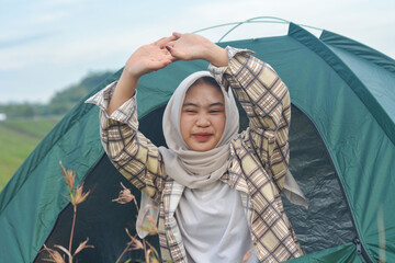 Asian Muslim woman and young Asian Muslim girl wake up in camp