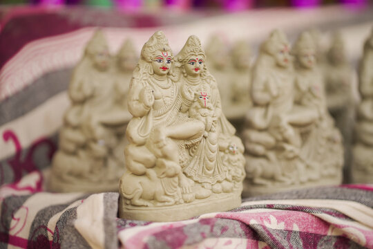 Clay idol of Lord Shiva and Parvati, Handmade Shiv Parvati statue, Traditional clay murti of Bholenath Parvati, Divine Shiv Parvati figurine stock photo.