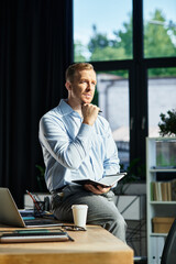 Handsome young businessman contemplating his next strategic move in a modern office setting