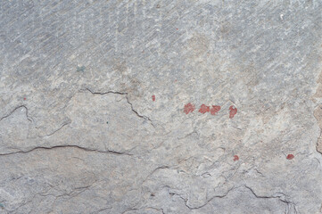 Weathered Concrete Surface Showing Cracks and Stains Evoking a Sense of Age and Durability