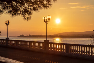Gelendzhik resort. Embankment at sunset. Balustrade and promenade in slanting sunset rays. Caucasus...
