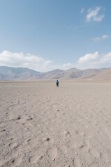man walking on the sand dunes