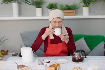 Elderly woman preparing fruit salad at home in the living room