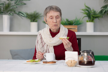 senior woman eating breakfast in a dining room