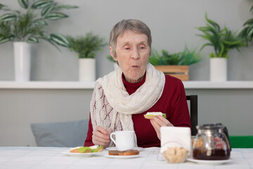 senior woman eating breakfast in a dining room