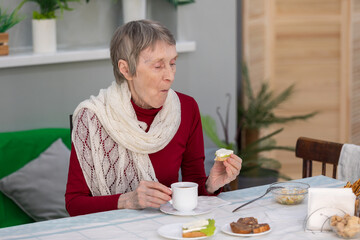senior woman eating breakfast in a dining room