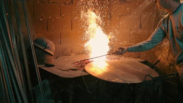 Traditional coppersmith workshop for copper brewing pots manufacturing. This handmade brewery kettles will be used for making traditional alcohol brandy drinks. Small traditional business concept.