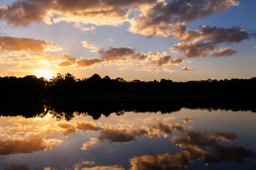 Sunset sky and soft clouds mirrored in reflection on glassy waters at Walka Water Works