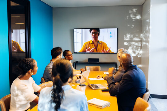 Team engaging in a video conference call inside a professional office setting