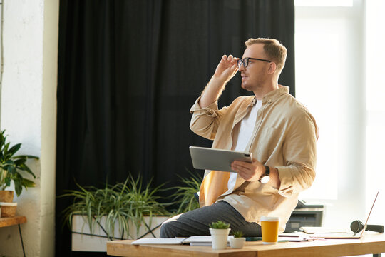 Inspiring business professional working thoughtfully in modern office environment