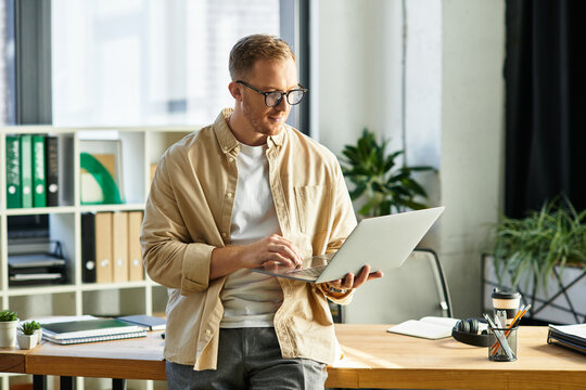 Handsome young businessman working diligently in a modern office environment