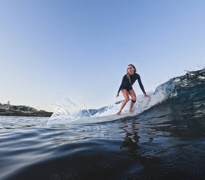 Woman surfing longboard on small clean wave