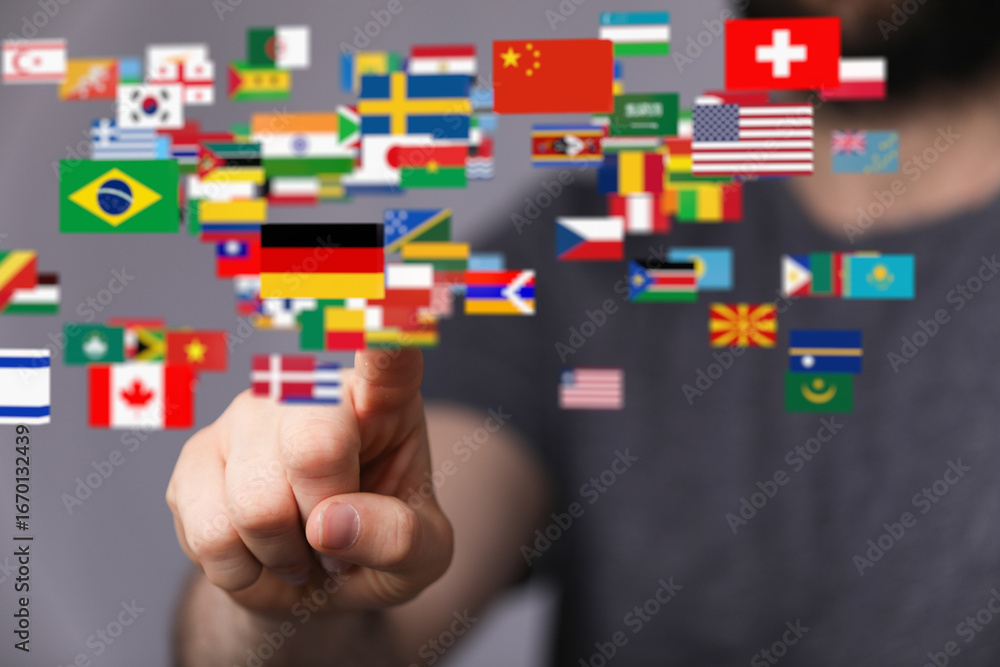Poster person's finger interacts with a digital display of world flags, symbolizing global connection and c