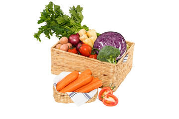 Fresh harvest of vegetables in wicker baskets on a white background
