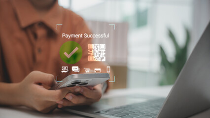 Hand holding smartphone with QR code showing payment successful. Concept of digital transaction, mobile banking, e-commerce, fintech solution and secure online payment system.
