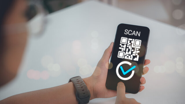 Close up of hand holding smartphone scanning QR code for digital payment, online verification, mobile authentication and secure access technology in daily business use.