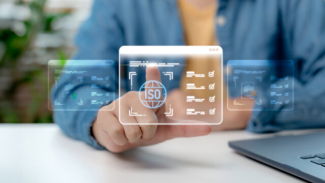 Businessman hand touching virtual ISO certification and quality management system interface. Concept of compliance, international standard, audit and document approval. - Powered by Adobe