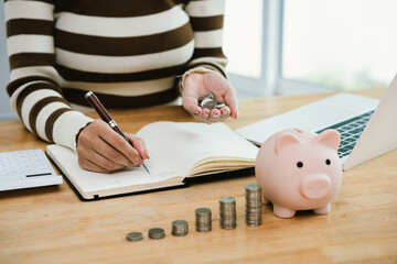 A woman holds a piggybank, symbolizing saving, retirement planning, financial security, investment...