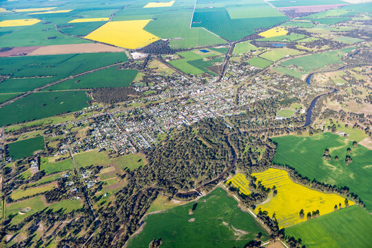 Aerial view of a small country town surrounded by lush farmland