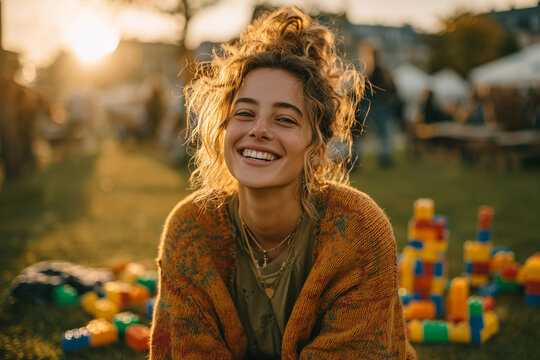 Joyful young woman enjoying a sunny afternoon at an outdoor gathering