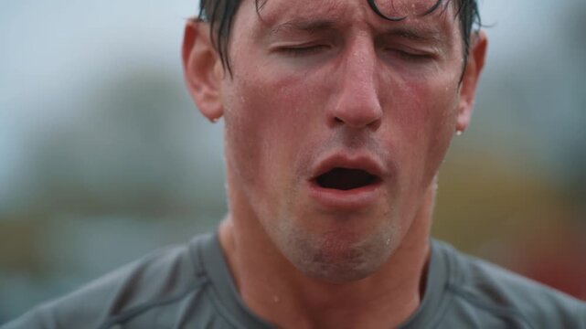 Muscular athlete dripping sweat, gasping after grueling workout, displaying raw fitness commitment and physical limits