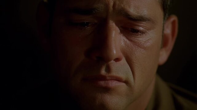 Soldier crying, tears streaming, expressing profound psychological wounds from military service and combat trauma