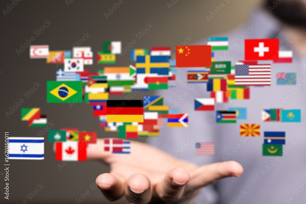 Aufkleber image of many national flags floating above a hand, symbolizing global unity and connection.
