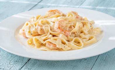 Creamy fettuccine shrimp pasta white plate savory sauce gourmet flavor