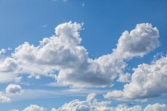 The sky is blue with a few clouds scattered throughout. The clouds are white and fluffy, giving the sky a peaceful and serene appearance