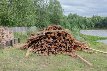 Pile of wood is stacked in a field