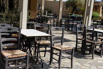 Stock photo of empty tables and chairs at an outdoor restaurant.  Perfect for hospitality, travel, or summer themes.