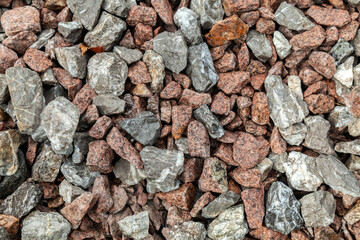 Pile of rocks with some gray and red ones
