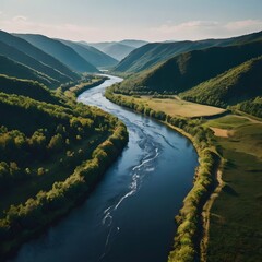 Serene River Winding Through Lush Green Valley Surrounded by Mountain Ranges Under Clear Sky