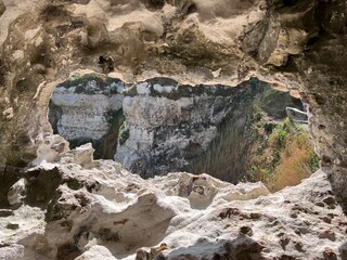 A picturesque grotto with a hole in the white rocks Etretat in Normandy, France
