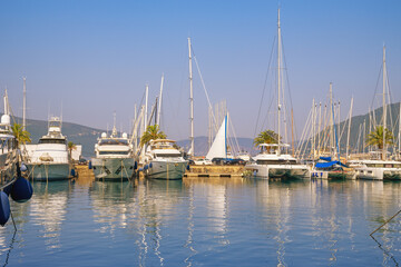 Fototapeta premium Yachts and sailboats in marina on sunny day. Montenegro, Adriatic Sea, Bay of Kotor. Porto Montenegro marina in Tivat city
