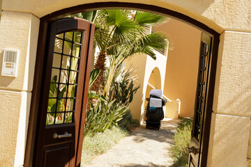 Clean towels and linens are wheeled along a resort pathway.  Luxury hotel amenities.