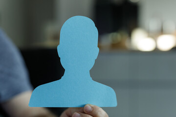 Blue paper cutout of a person, ideal for profile pictures, privacy, or anonymity. Perfect for...