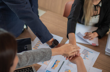 A diverse group of businesspeople and colleagues brainstorm in a conference room, planning...