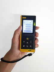 Digital laser distance meter tool, measuring device for construction, interior, or architecture. On white background.