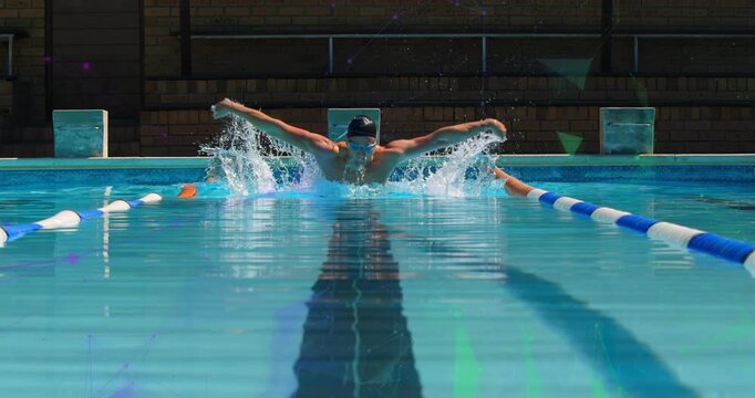 Swimmer gliding underwater then breaking surface in pool lane and powering stroke for training